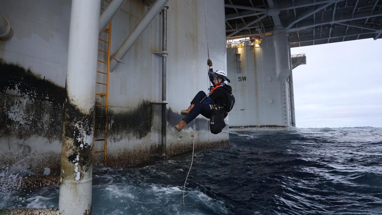Greenpeace activists scale Woodside’s Scarborough gas platform