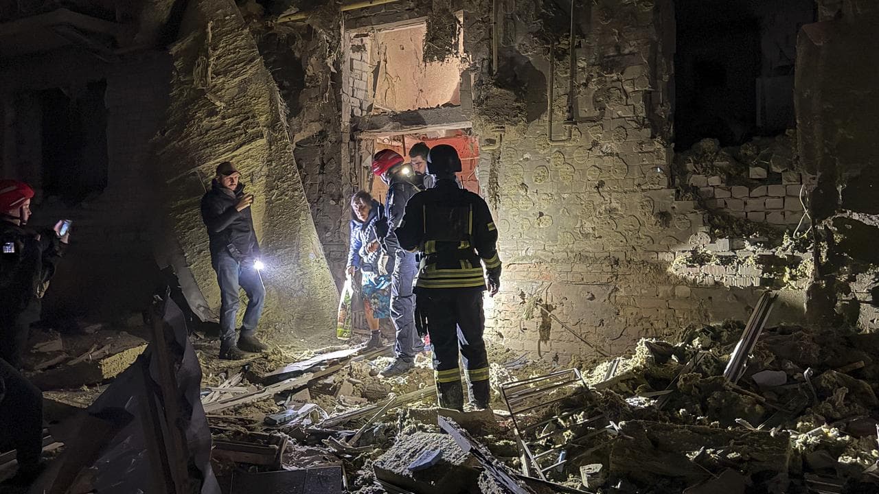 Rescuers at the site of a Russian strike in Zaporizhzhia, Ukraine