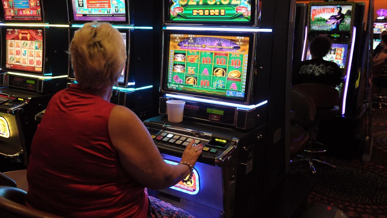 Gamblers play poker machines (file image)