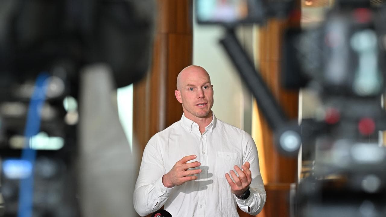 man addresses media cameras