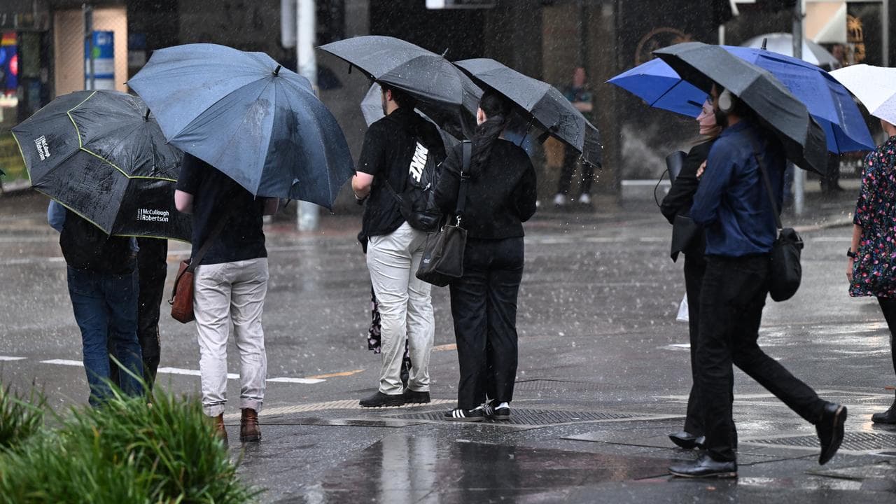 People walking in heavy rain in Brisbane