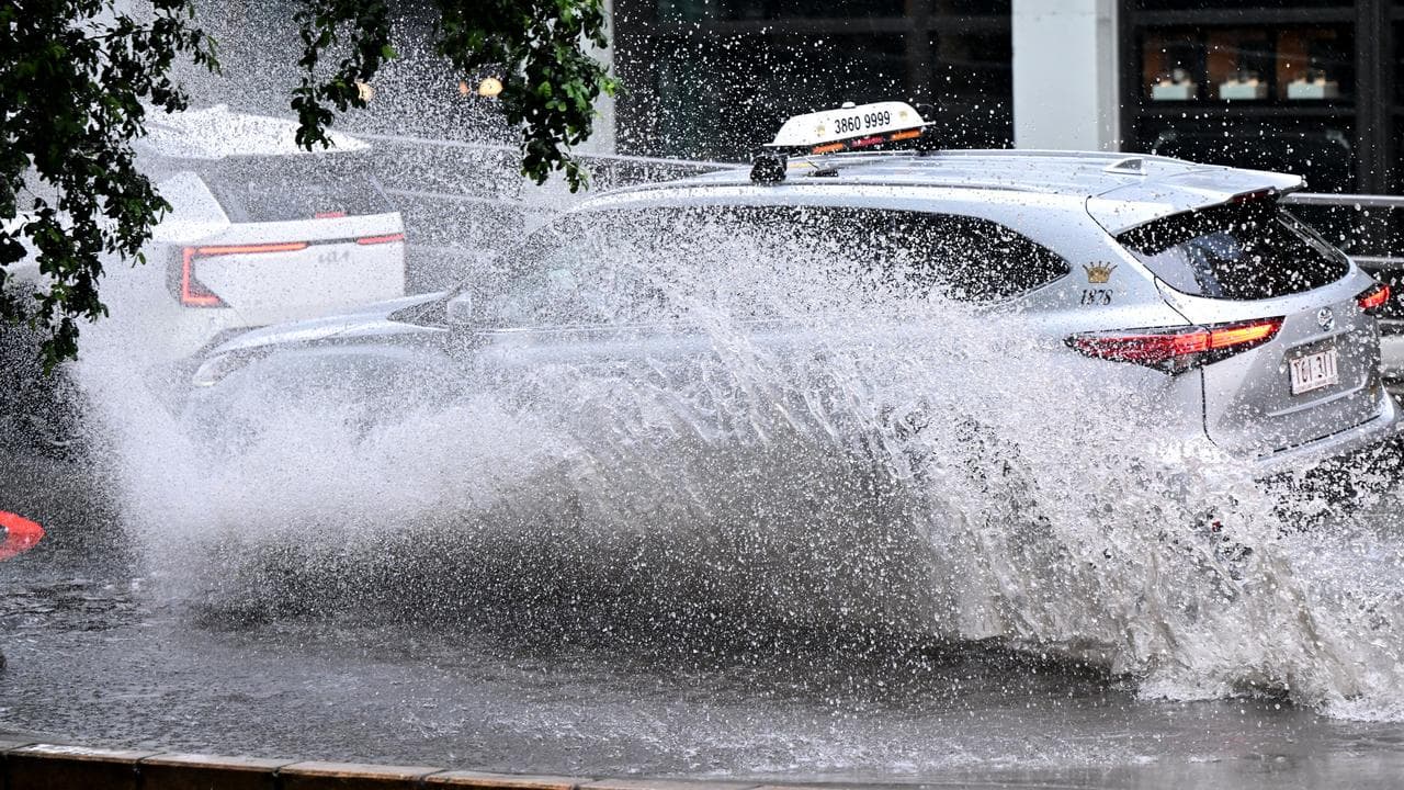 A car driving along a waterlogged street