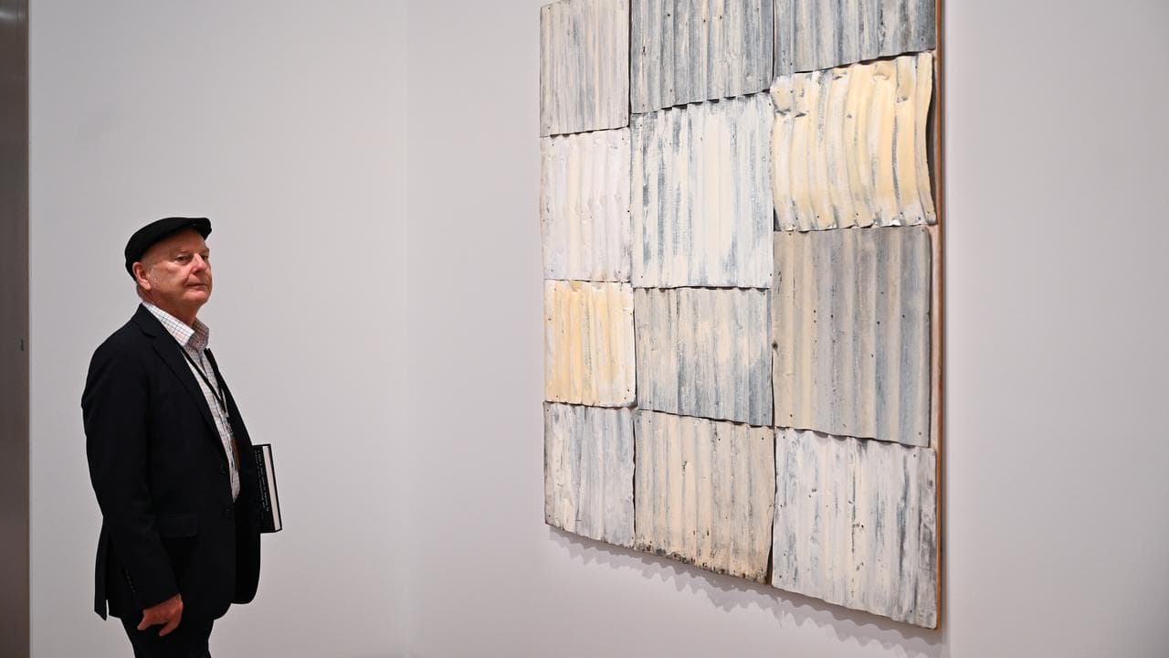 A person looks at an artwork