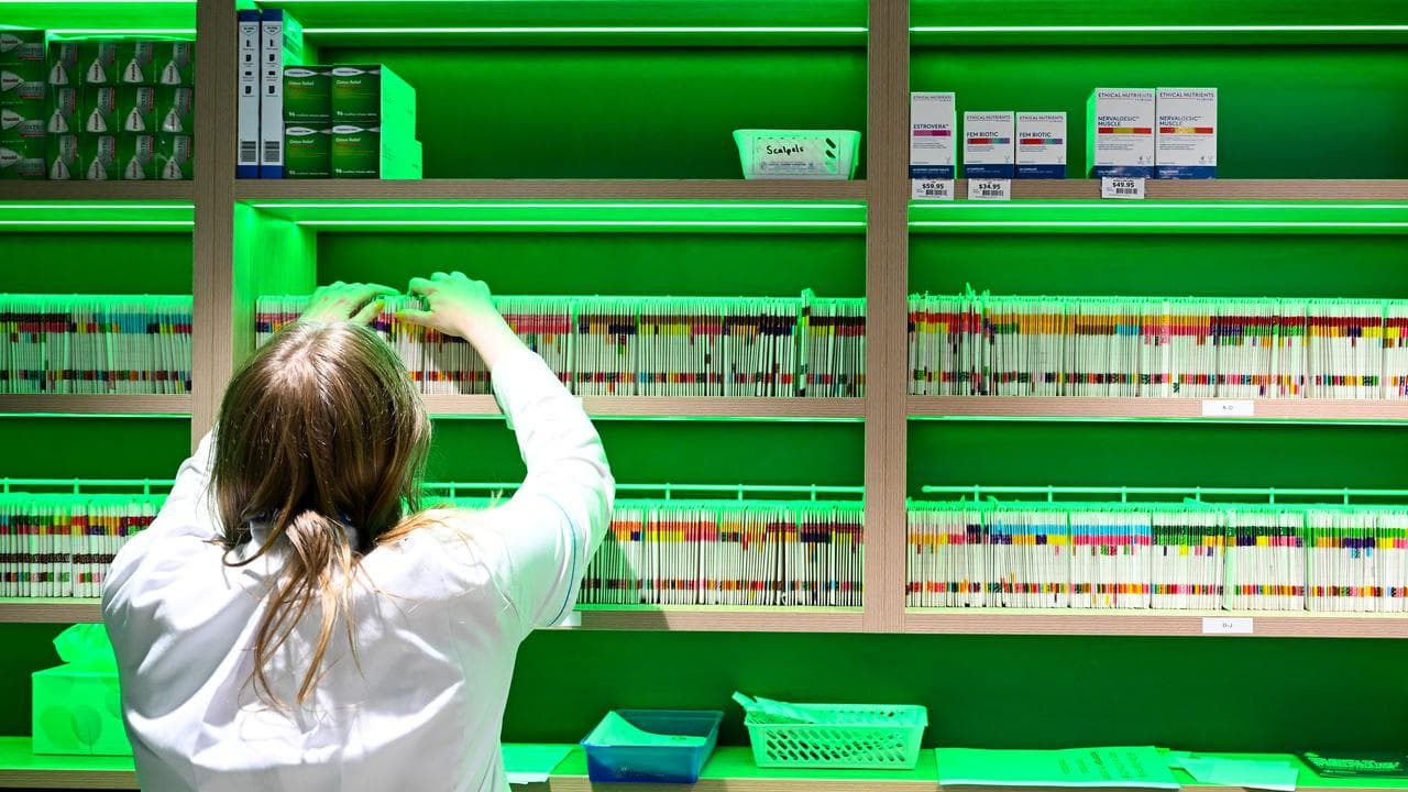 A pharmacist prepares scripts