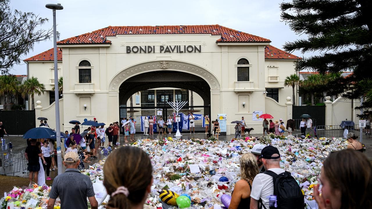 Mourners place flowers at a memorial at Bondi Beach