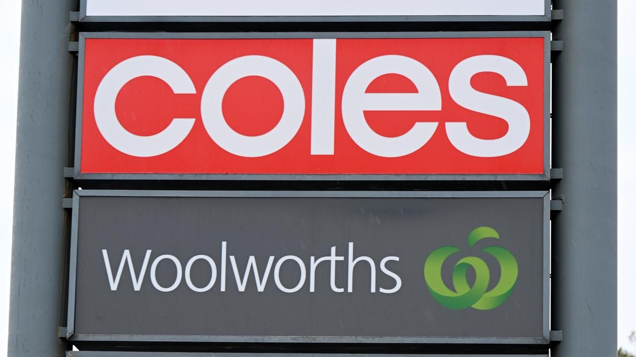Signage for Coles and Woolworths (file image)