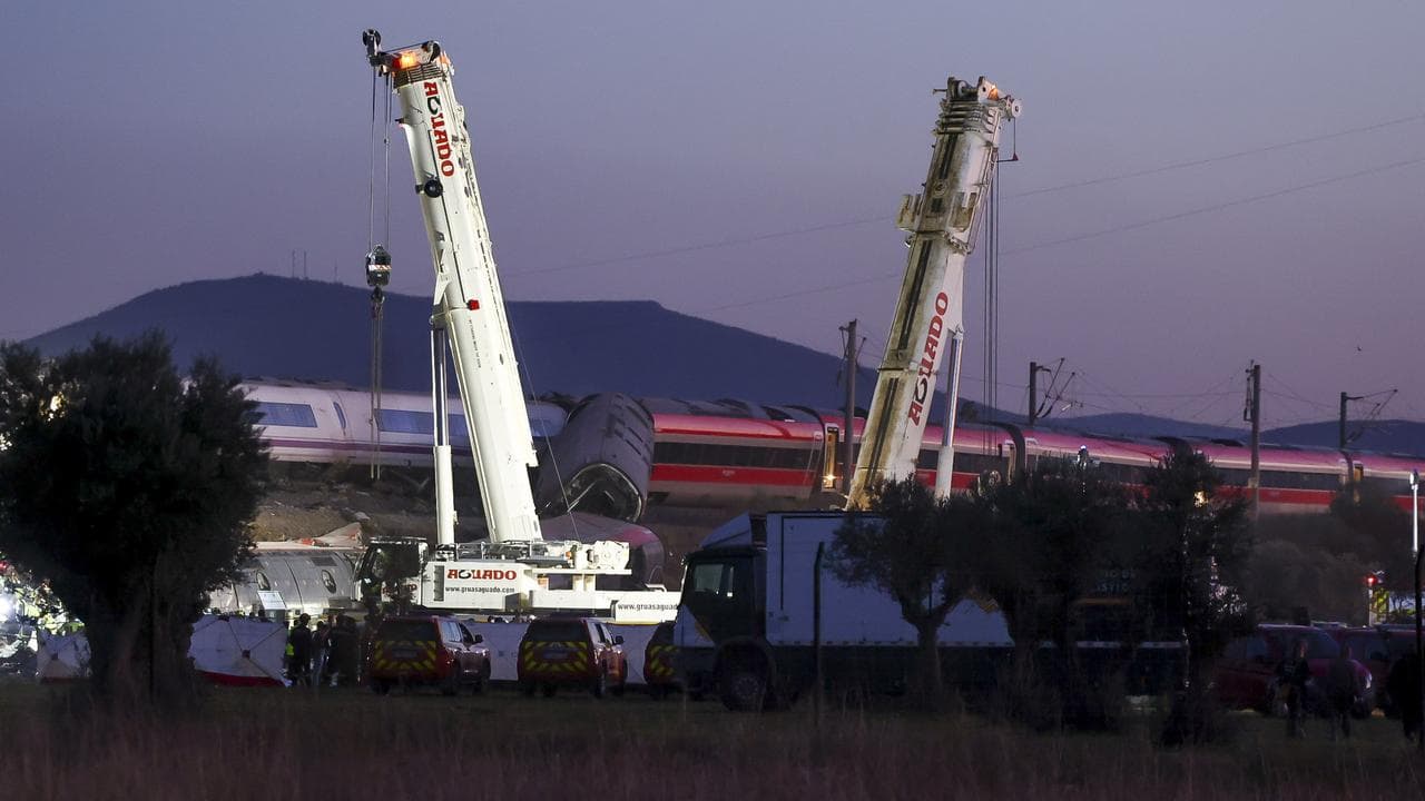 Rescuers with heavy machinery at the train crash site in Urda, Spain