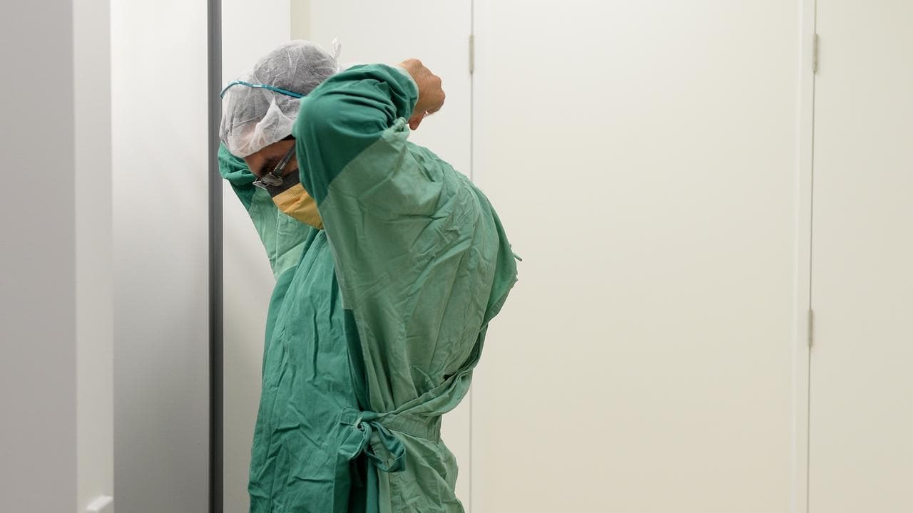 A surgeon prepares for theatre