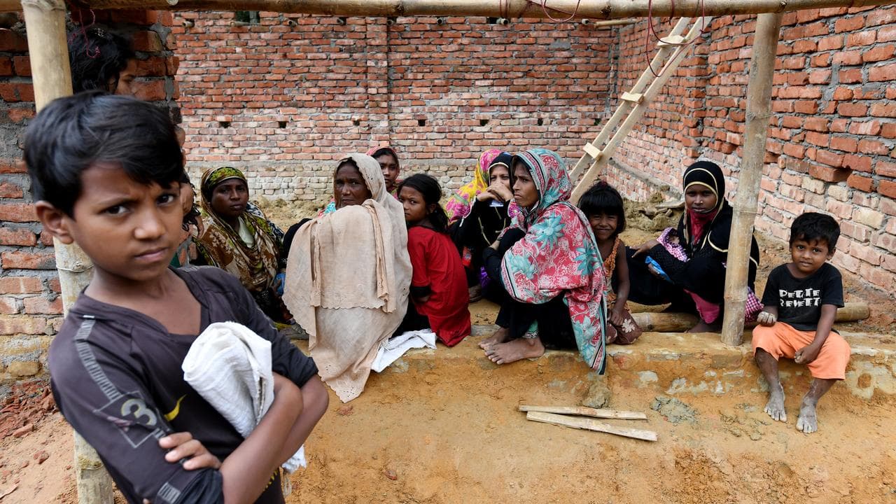 Rohingya children wait for their parents to receive aid in Bangladesh