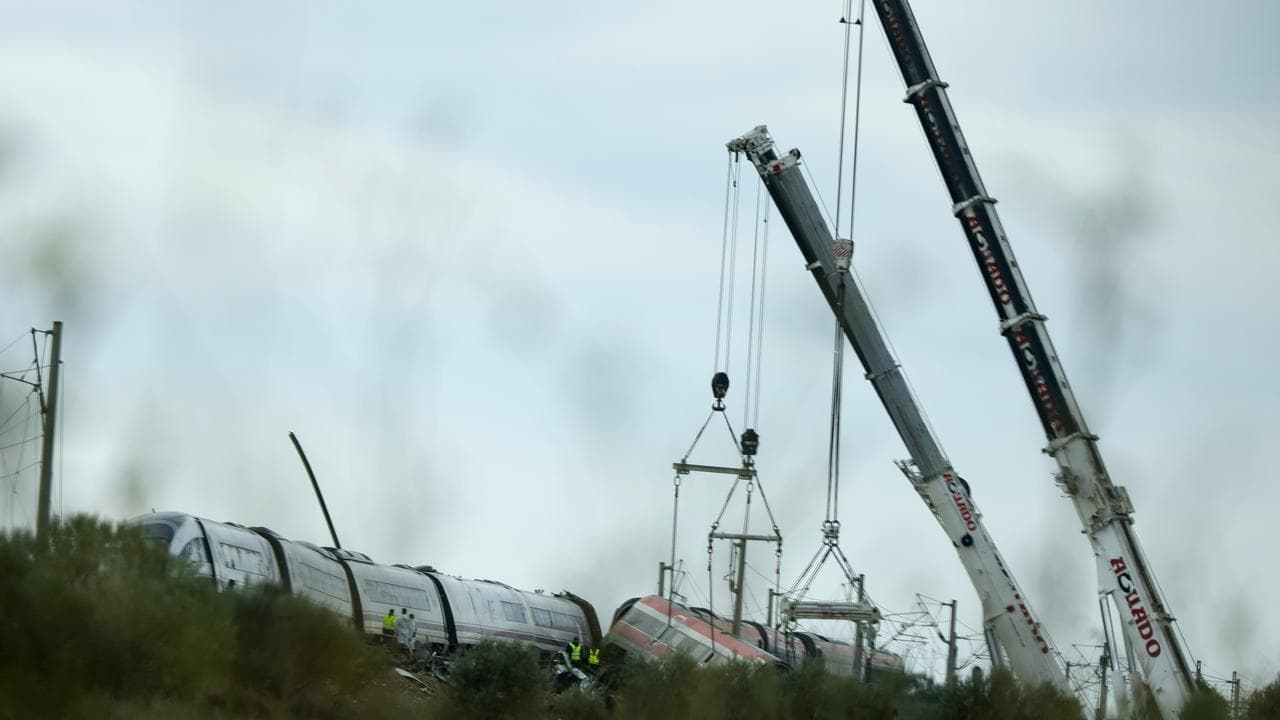 Cranes at the scene of a train collision near Urda, Spain