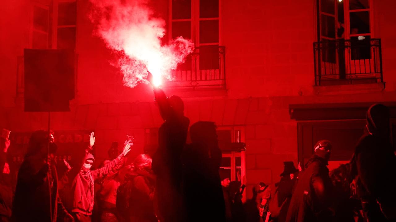 A protester waves a flare during a demonstration