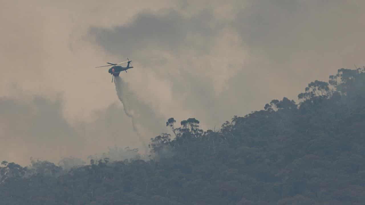 Bushfire rages but cool change a chance to check damage