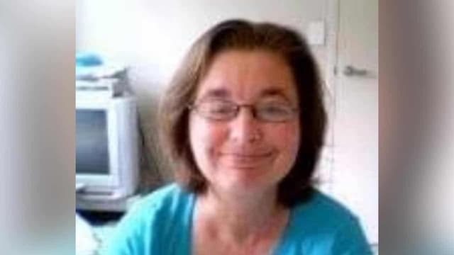 Woman on murder charge over body-in-wall cold case