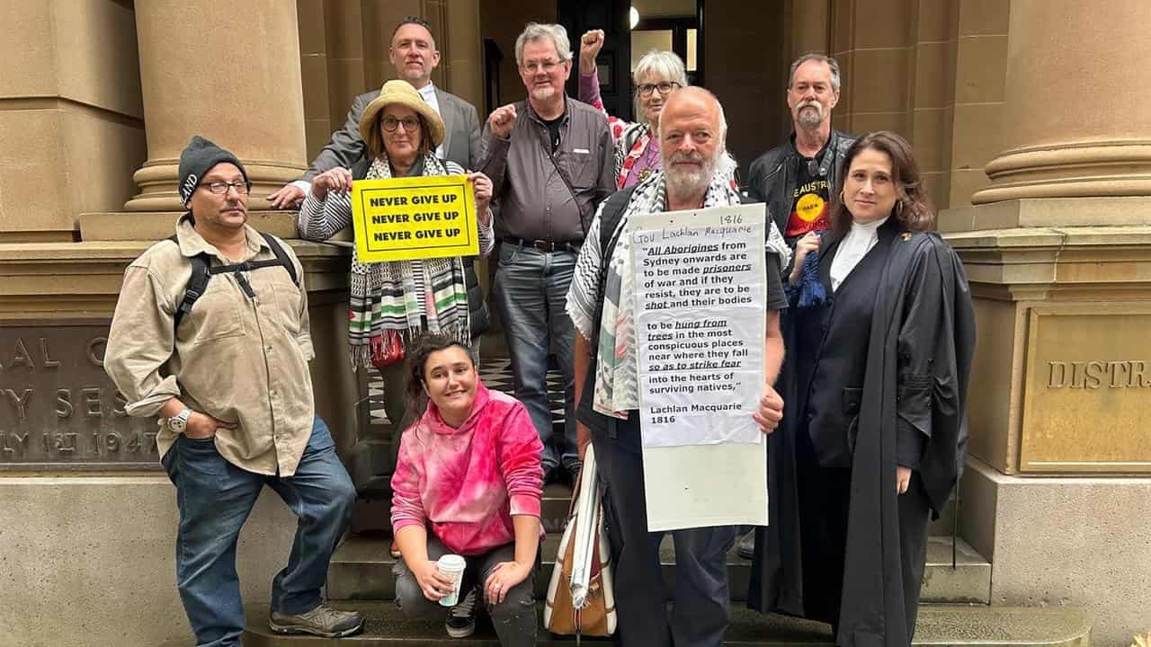 Massacre order poster on coloniser statue in court test