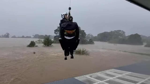 Floods strand 48,000 people amid flurry of roof rescues