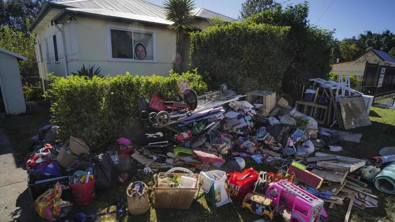 Flood-stricken locals begin mop-up, sweat on support