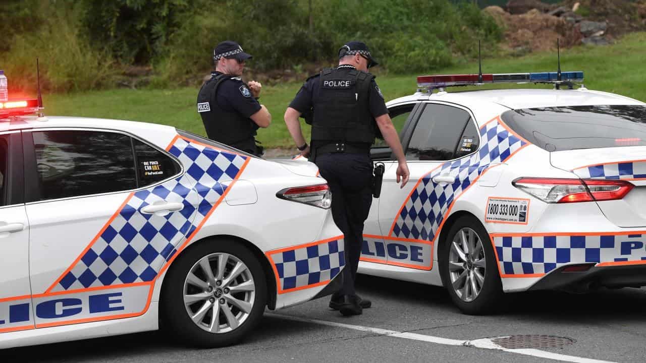Two dead, carer charged after car crashes into tree