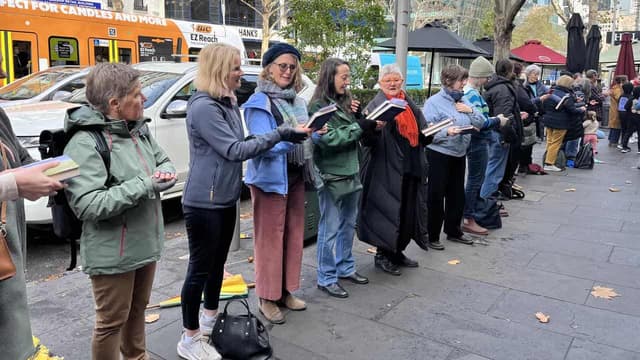 Tome by tome, human chain moves historic bookstore