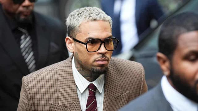 Singer Chris Brown denies lesser 'bottle attack' charge