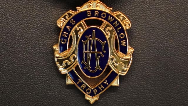 Four men charged after Brownlow Medal betting scandal