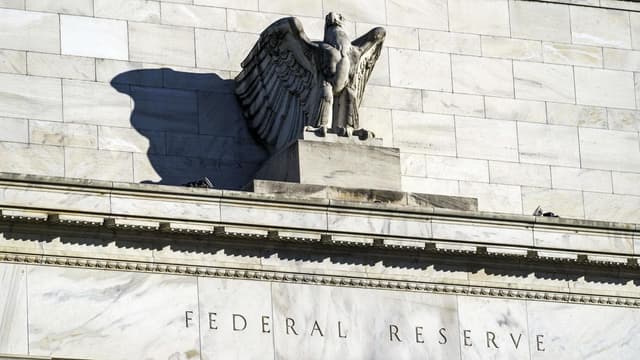 Divided US central bank cuts rate, signals pause