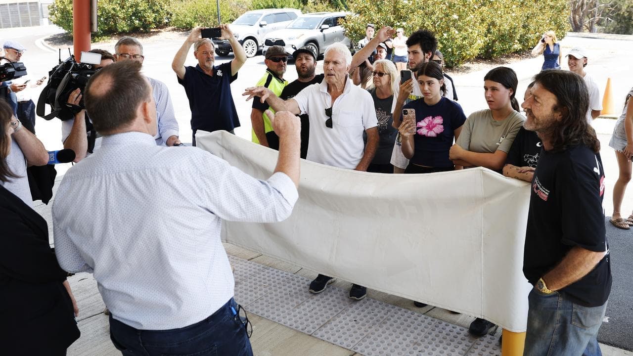 Premier evades angry mob amid backdrop of charred hills