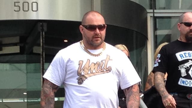 Sniper who gunned down bikie boss unmasked by court