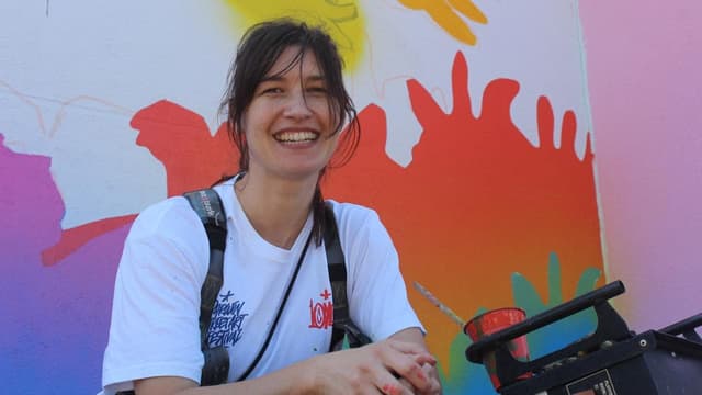 Mural artists creating downtown city wonderwalls