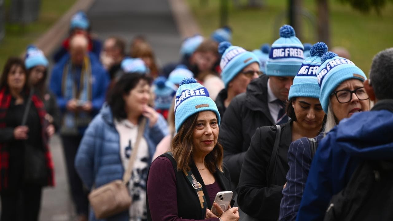 Sea of MND beanies for AFL legend's funeral