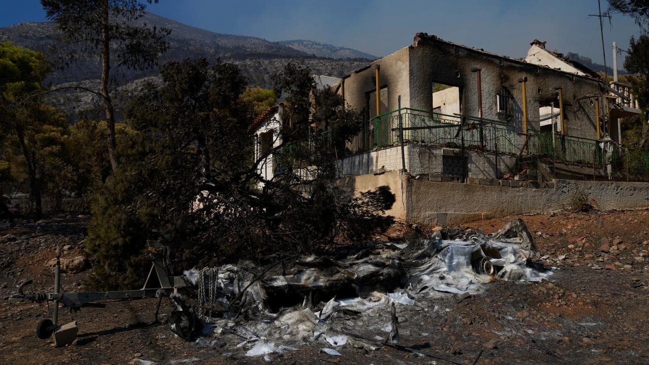 Fires ease in Greece as people return to gutted homes
