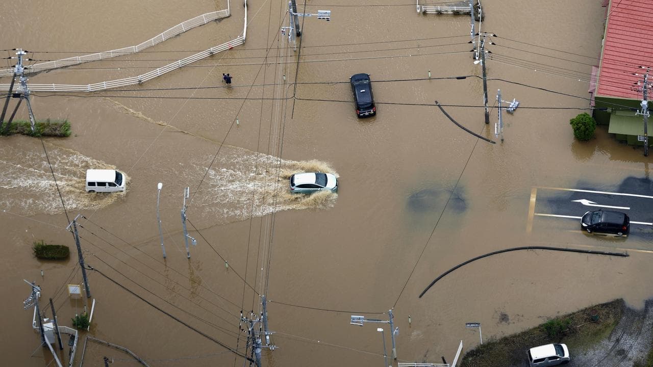 Eight dead, thousands stranded as rain slams Japan