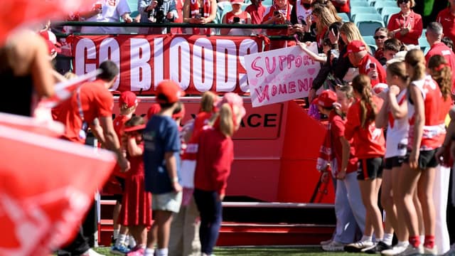 Swans fans turn out in tense return to footy field