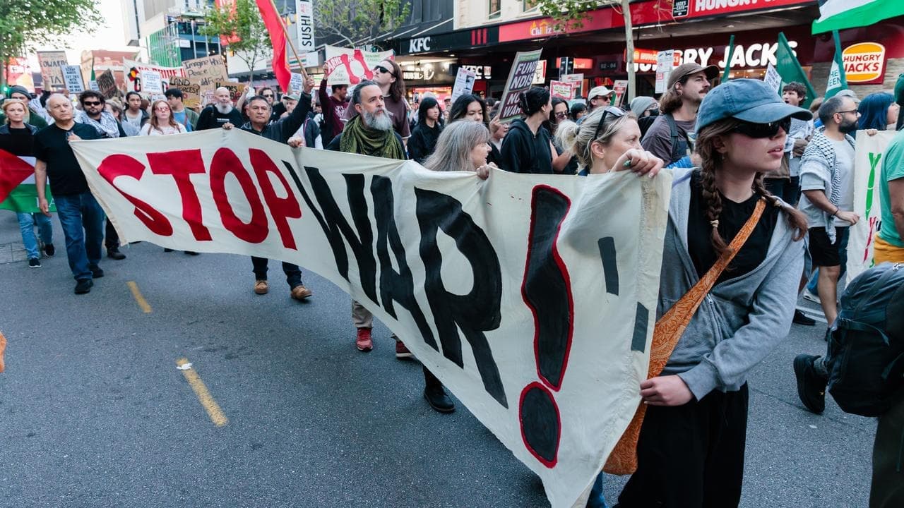 Protesters rally outside controversial weapons expo