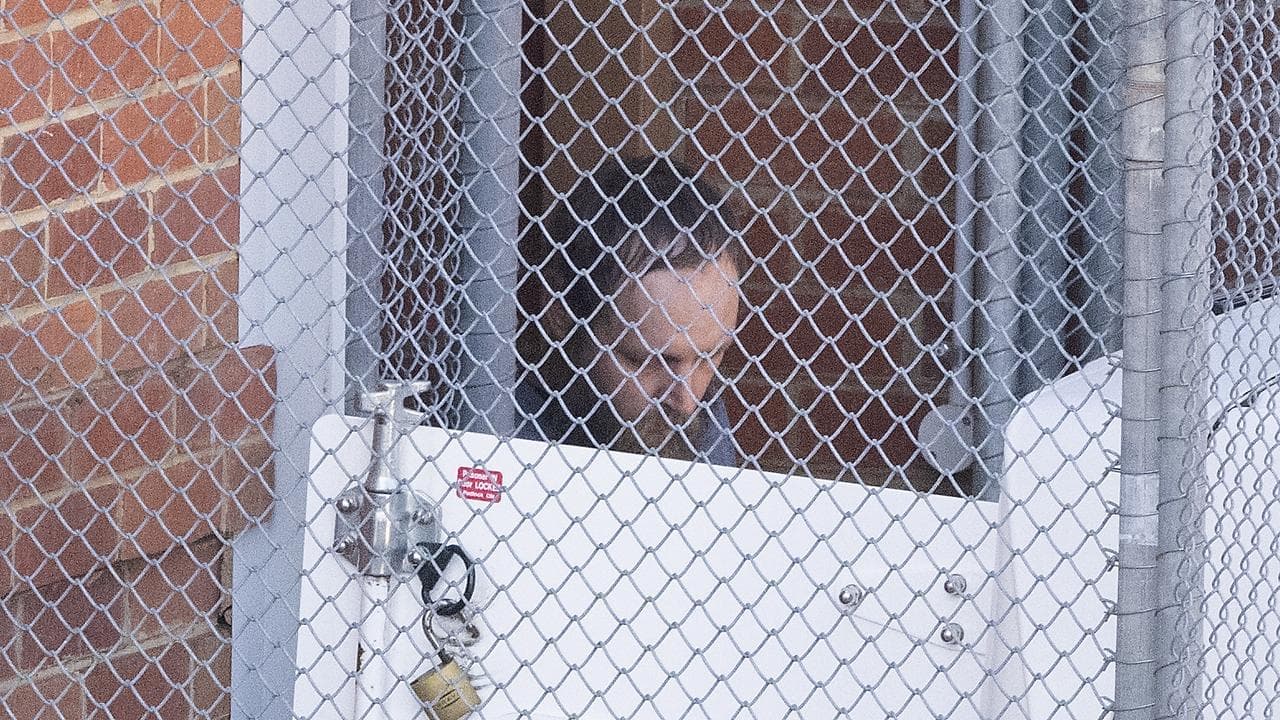 Silent, staring: alleged MP attacker appears in court