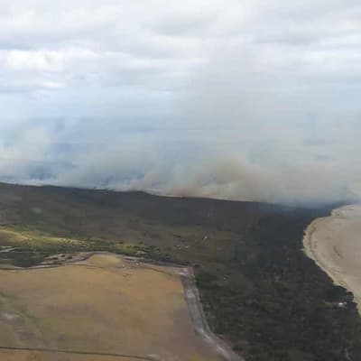 Bushfire downgraded after campers, residents evacuated