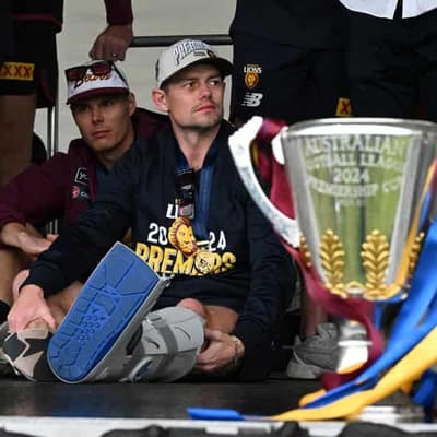 Lions star Neale celebrates premiership in moon boot