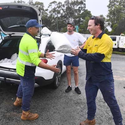 Sun bathing to sandbagging: nervous wait for cyclone