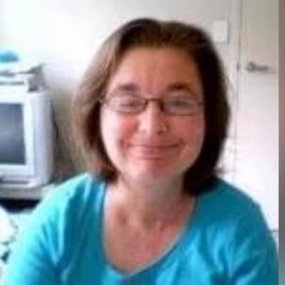 Woman on murder charge over body-in-wall cold case