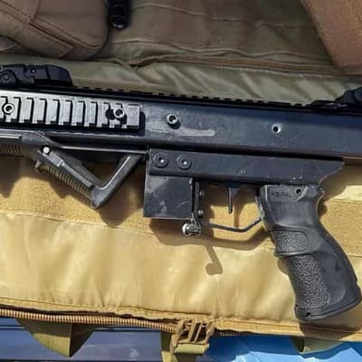 Former cop charged over home-made machine gun cache