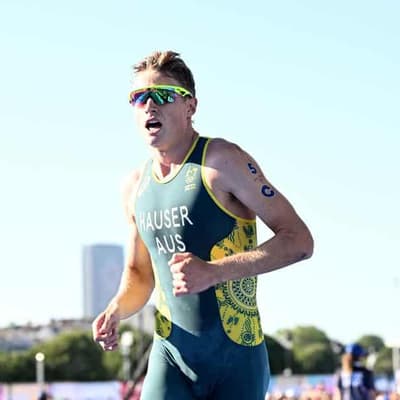 Hauser sprints to triathlon victory, leads world series