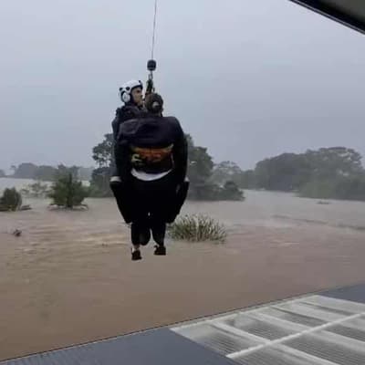 Floods strand 48,000 people amid flurry of roof rescues