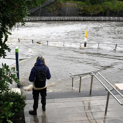 Father and son dead in river as flood threat grows