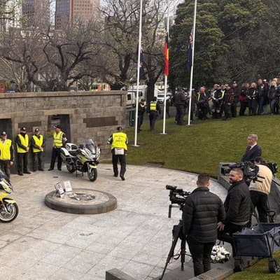 Police honour slain officers as manhunt continues