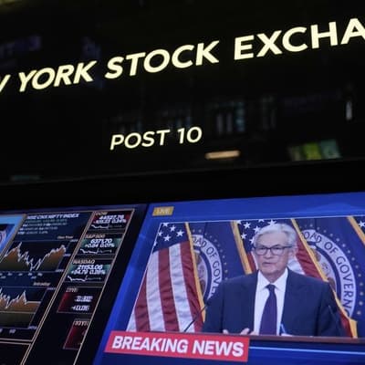 Wall Street lower as investors weigh Powell comments