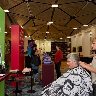 Social media ban trims budding young barber's following