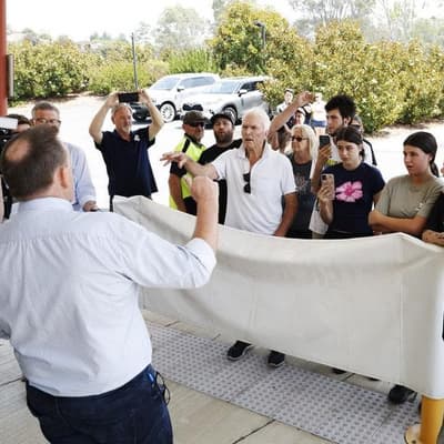 Premier evades angry mob amid backdrop of charred hills