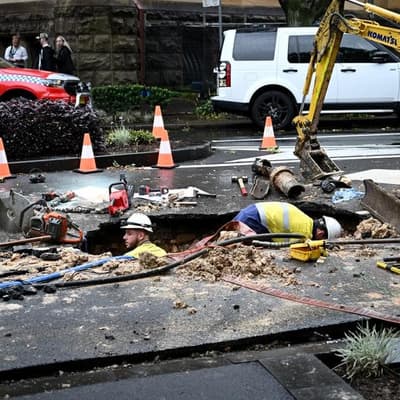 Sinkhole opens after rain deluge forces evacuations