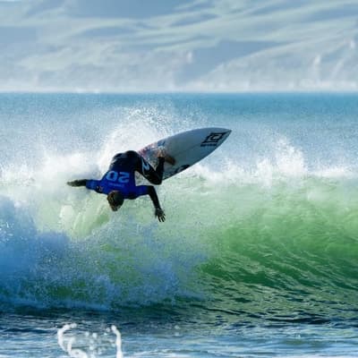 Cibilic flying Australian flag in New Zealand surfing