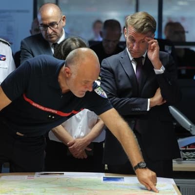 Macron visits fire zone, 'to win this battle together'