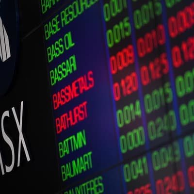 Aussie shares edge higher as iron ore tumbles